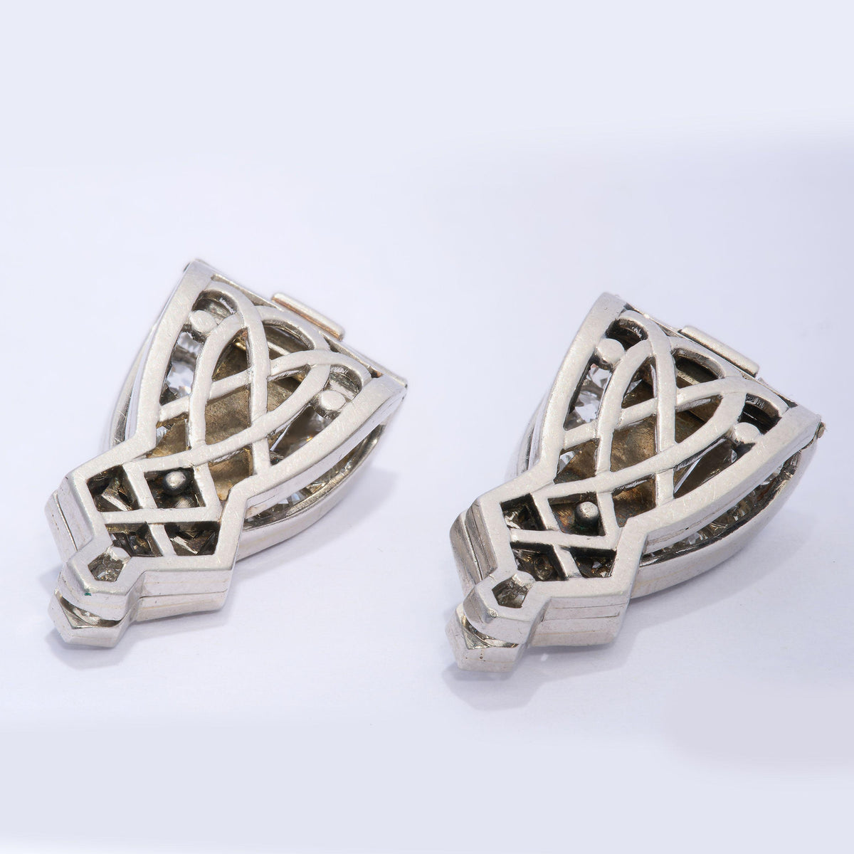 A pair of platinum clips set with round and baguette cut diamonds