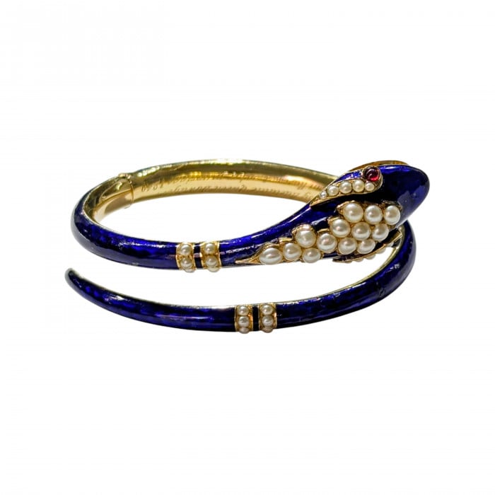 A snake bangle bracelet with pearls, ruby eyes and blue enamel, in yellow gold