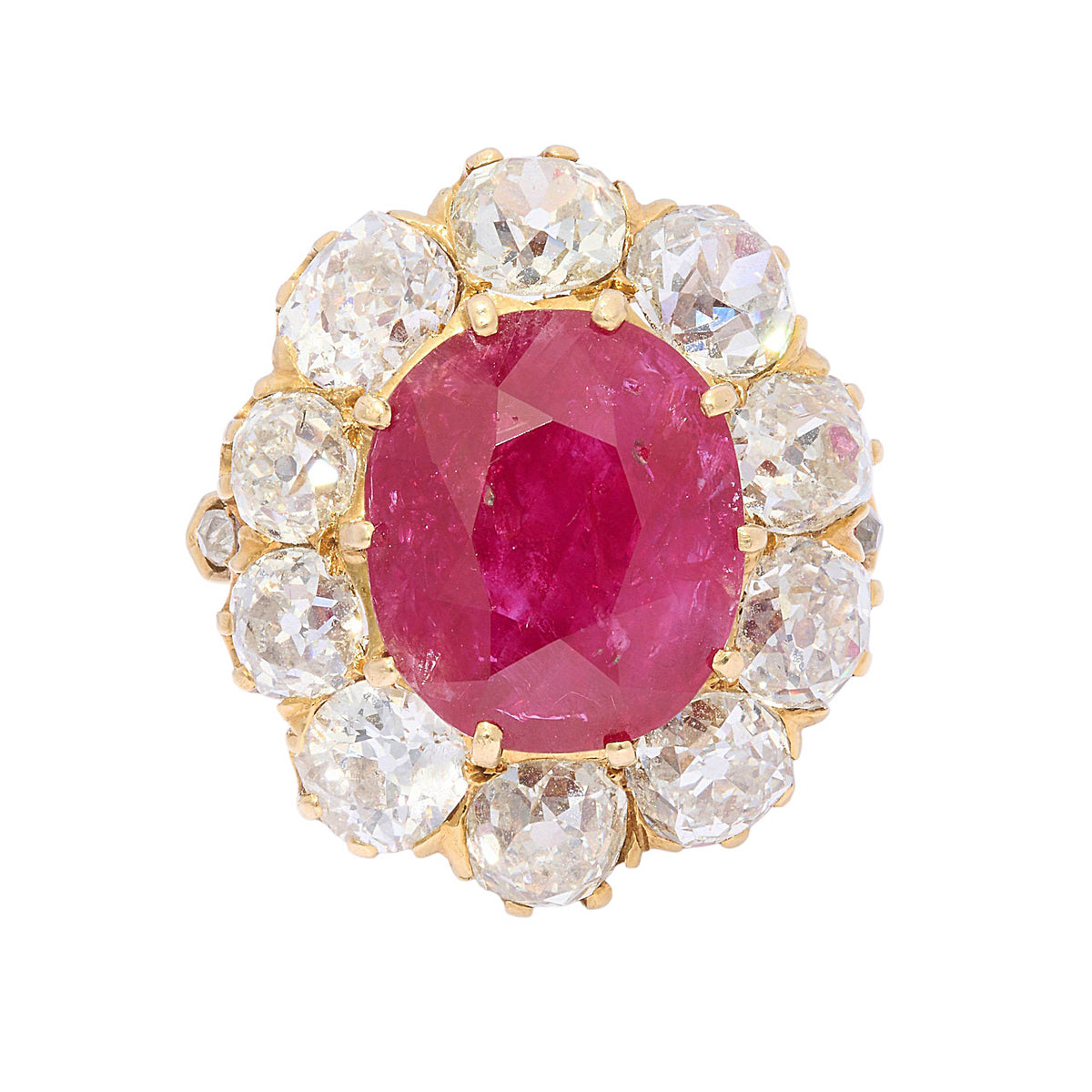 A French antique cushion-cut ruby and diamond oval-shaped cluster ring, with ten, old-cut diamonds in claw settings, mounted in yellow gold, with a French eagle head mark, for 18ct gold, circa 1890.