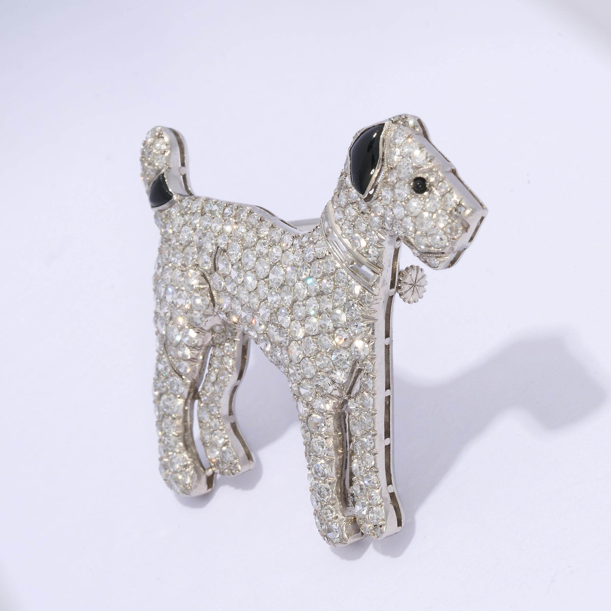 A diamond set terrier dog brooch with black onyx details, in platinum