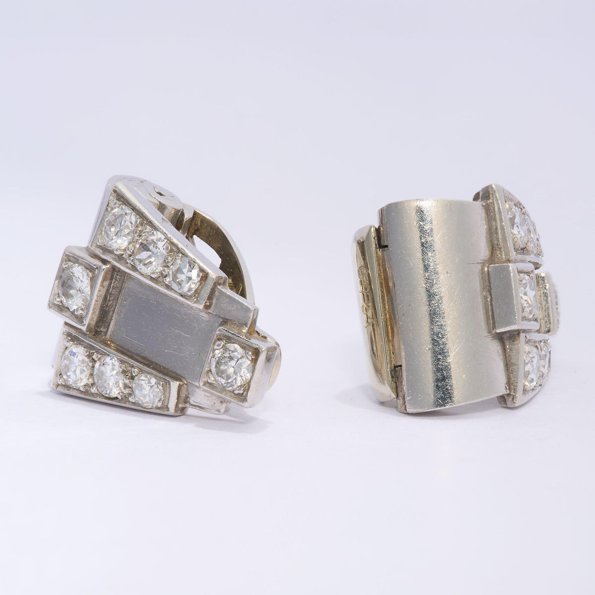 A pair of Art Deco round diamond clips, in platinum, with white gold fittings