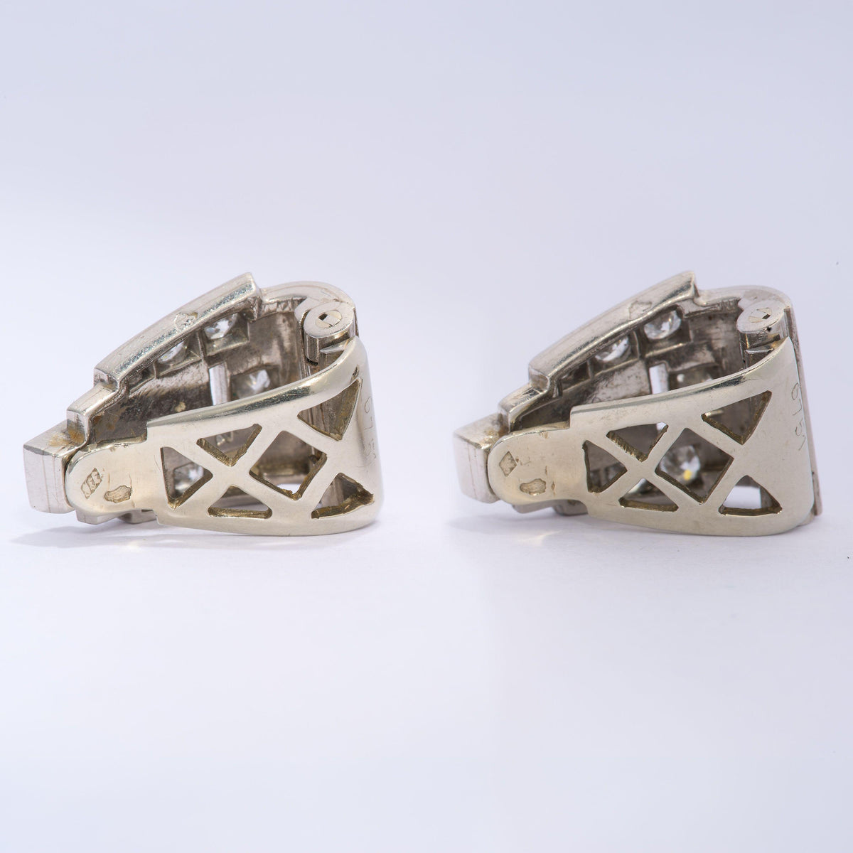 A pair of Art Deco round diamond clips, in platinum, with white gold fittings