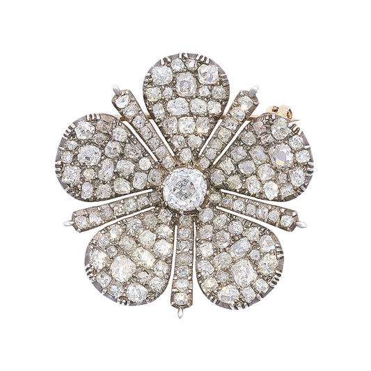 An antique old cut diamond flower brooch in silver and gold