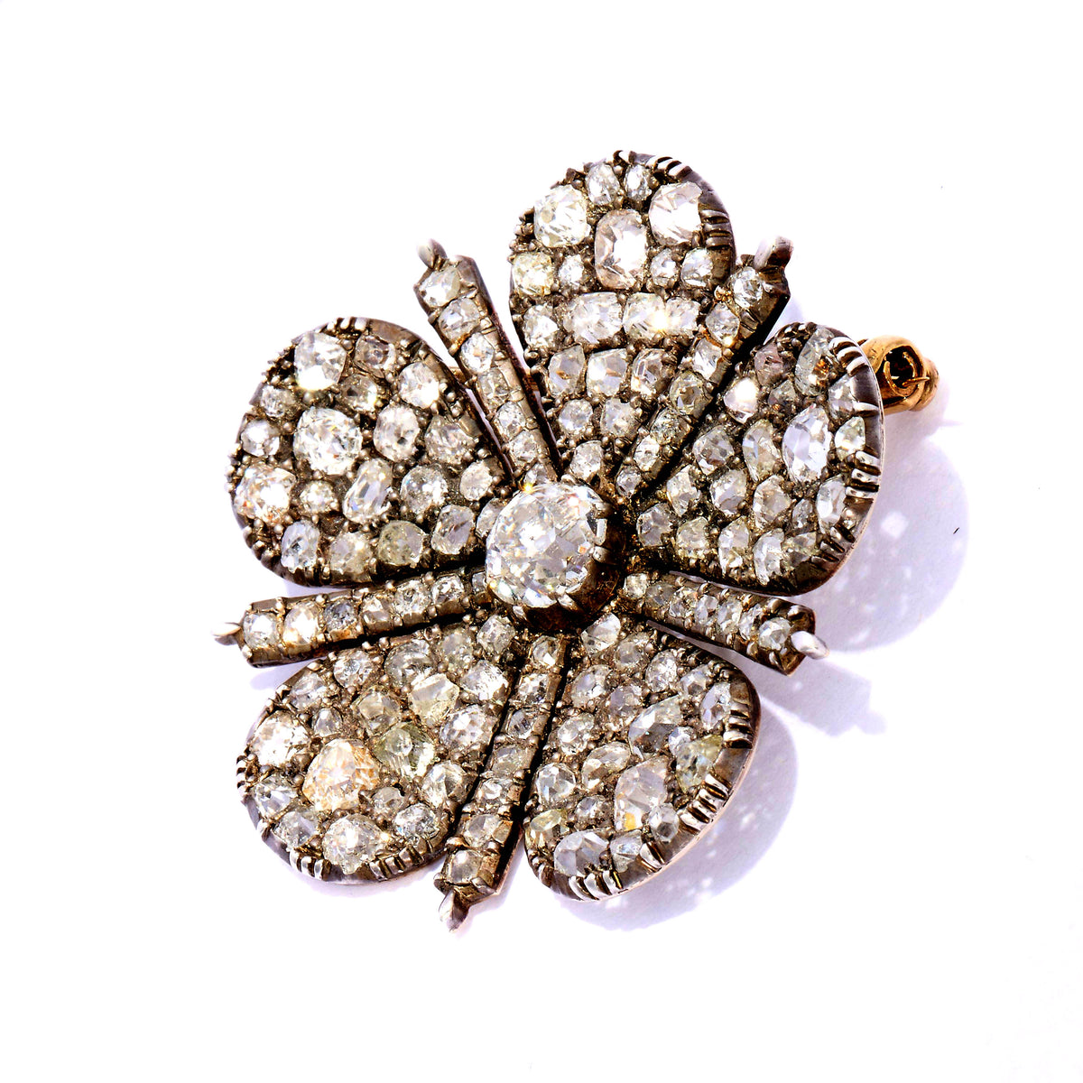 An antique old cut diamond flower brooch in silver and gold