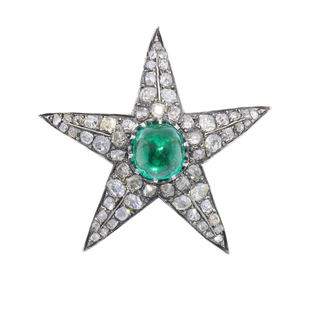 A star shaped brooch in silver and gold, with a cabochon emerald centre surrounded by old cut diamonds