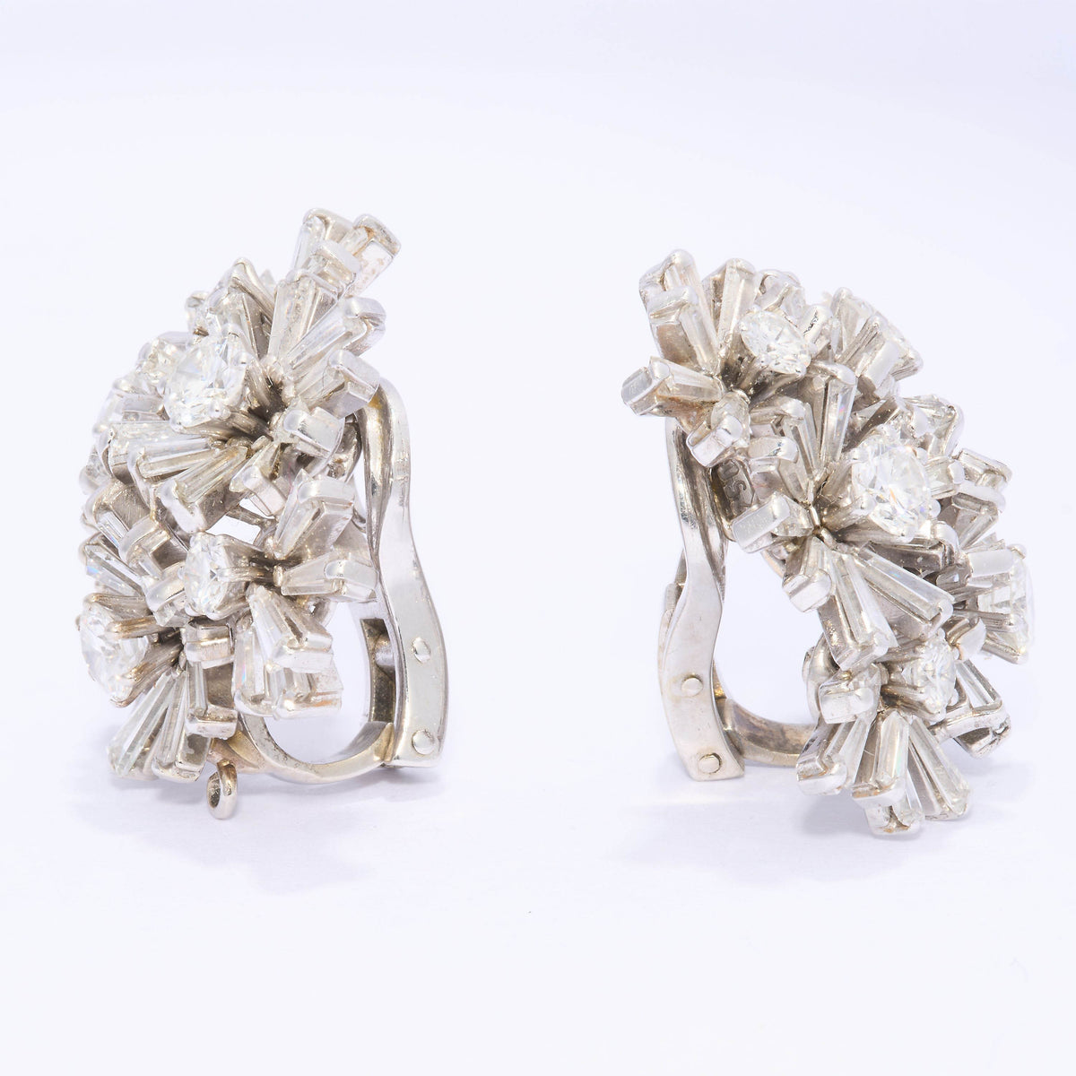A pair of vintage multi floral cluster earrings set with diamonds, in white gold, with clip fittings