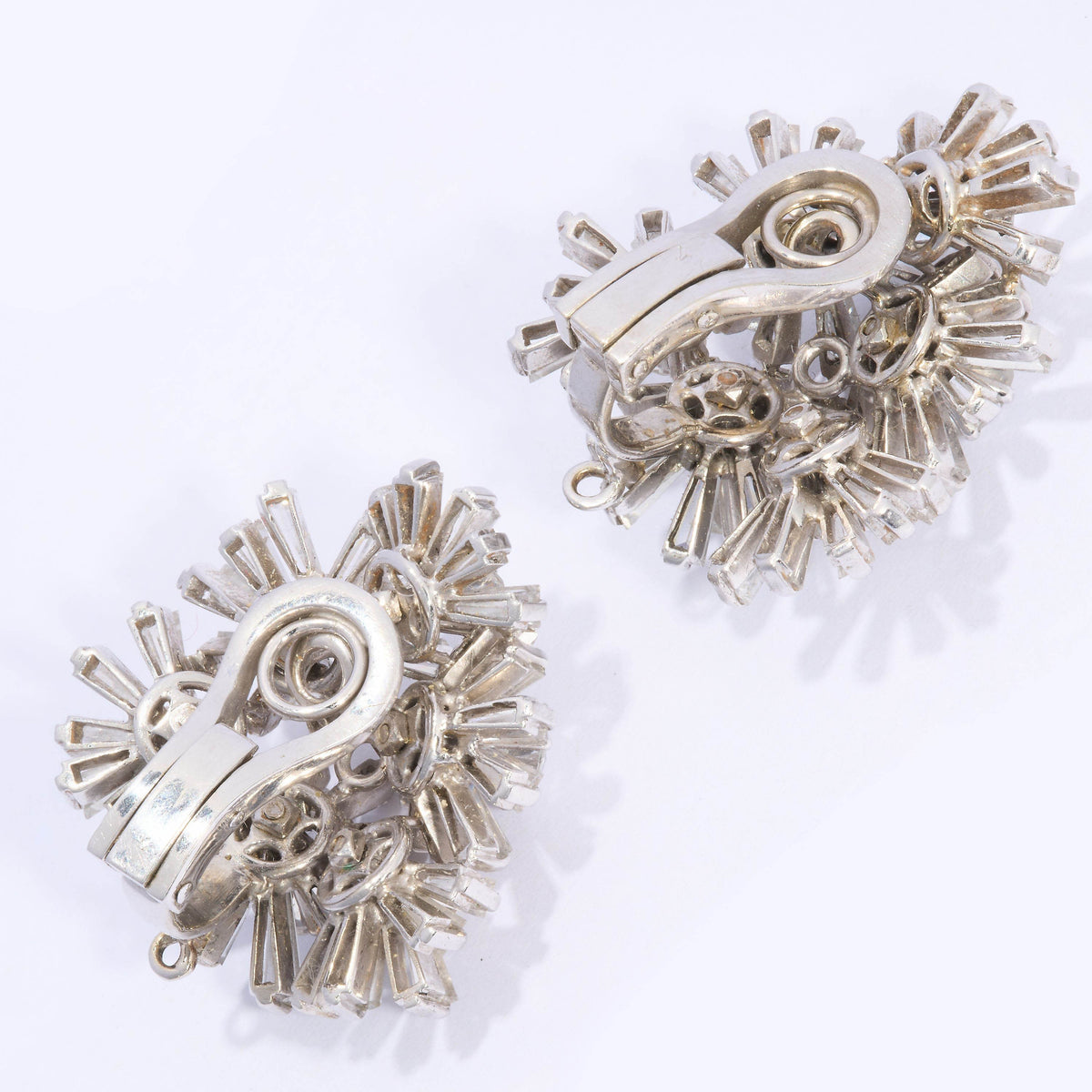 A pair of vintage multi floral cluster earrings set with diamonds, in white gold, with clip fittings