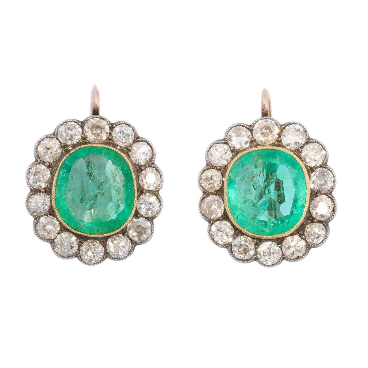 A pair of cushion-shaped emerald and old cut diamond cluster earrings in silver and gold