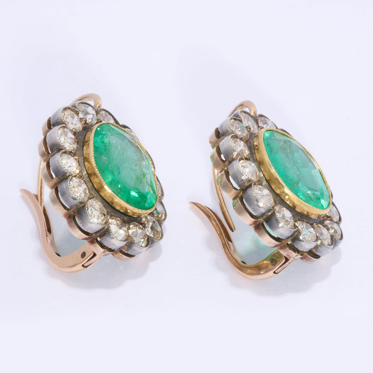 A pair of cushion-shaped emerald and old cut diamond cluster earrings in silver and gold