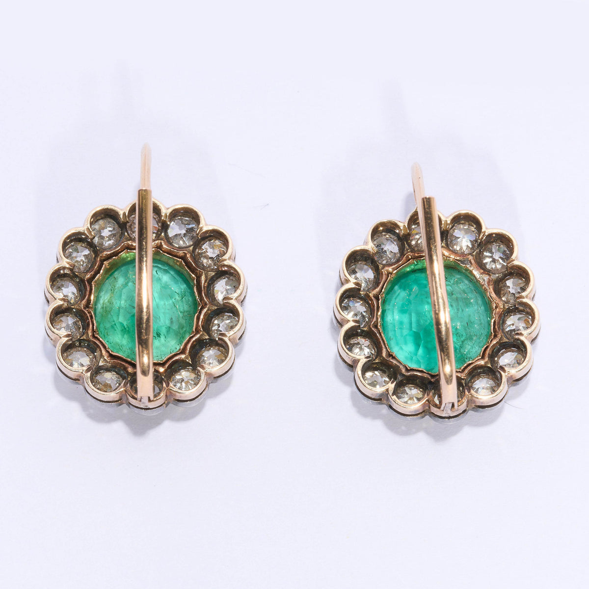 A pair of cushion-shaped emerald and old cut diamond cluster earrings in silver and gold