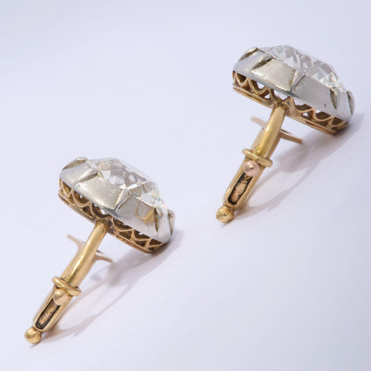 A pair of old cut diamond single stone earrings in silver, with yellow gold hinged clip on fittings
