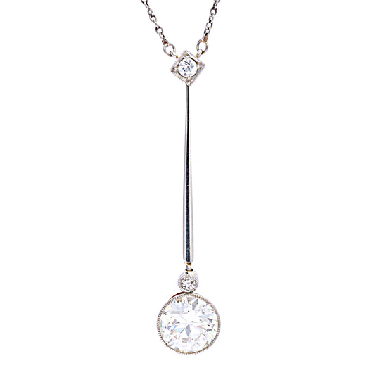 A round diamond bar drop pendant necklace with integrated chain, in platinum and gold