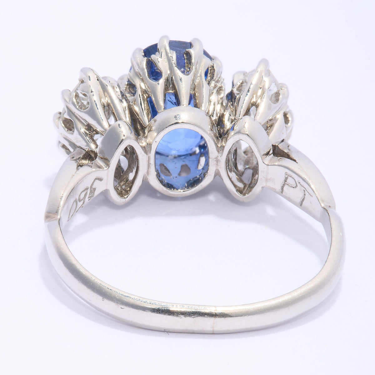 An oval sapphire and marquise cut diamond three stone ring in platinum