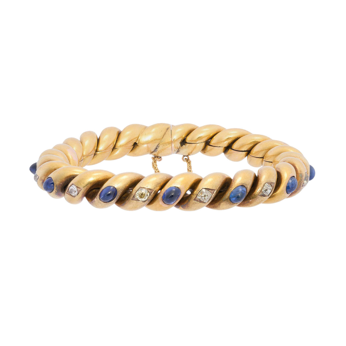 A yellow gold twisted bracelet set with cabochon sapphires and old cut diamonds