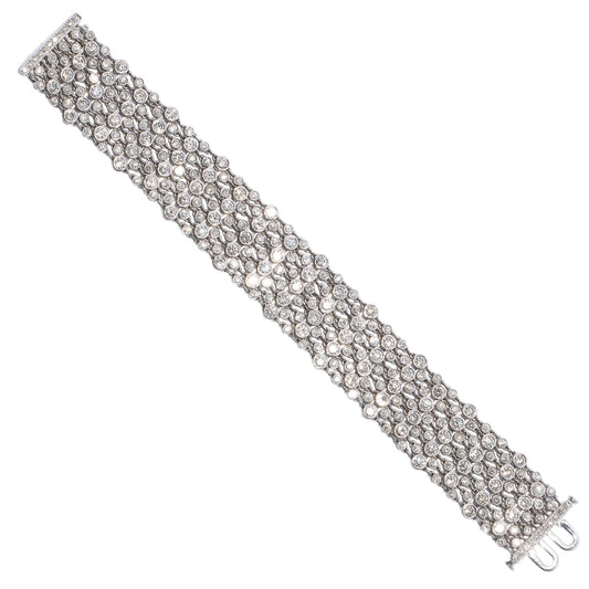 A wide multi-row bracelet set with brilliant cut diamonds in white gold