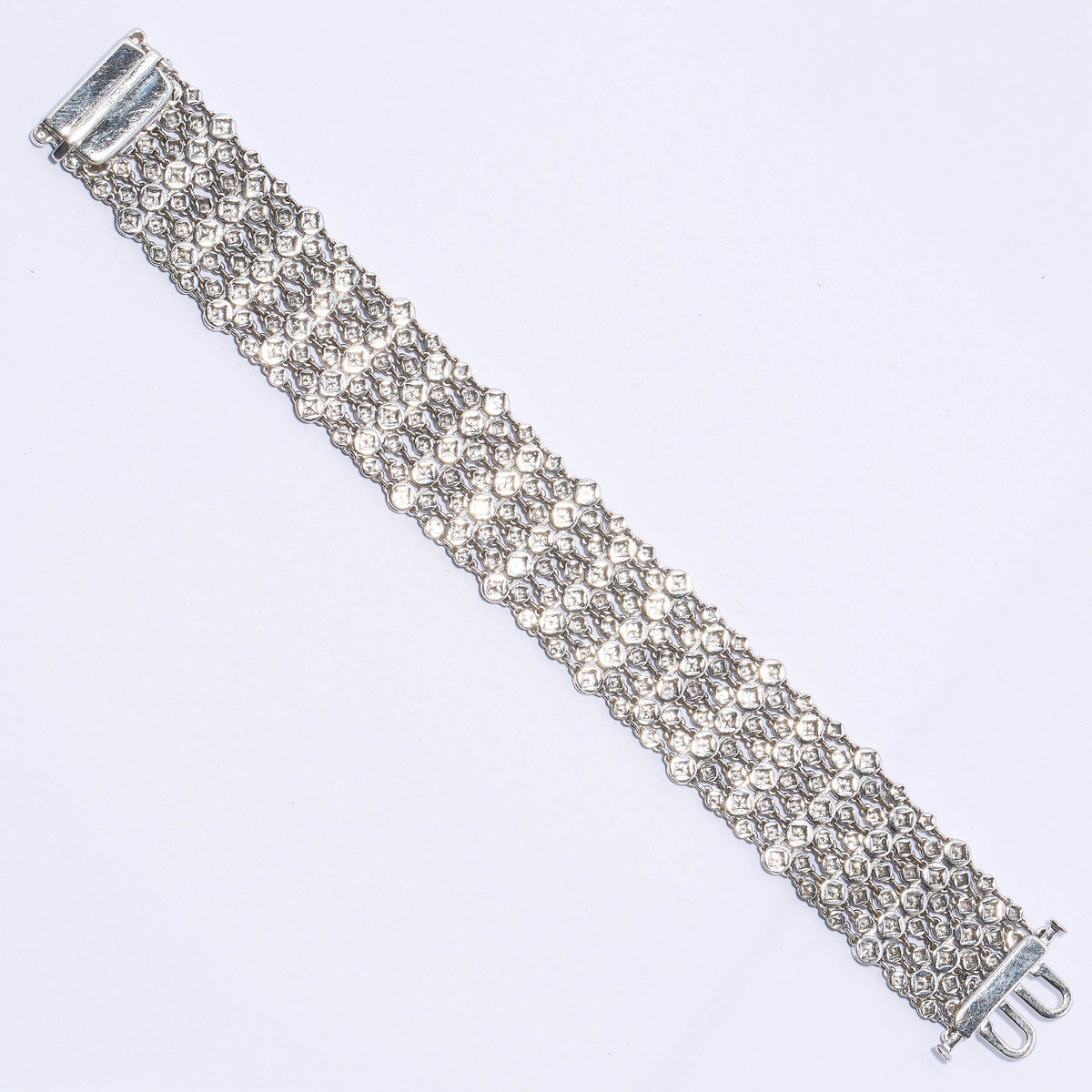 A wide multi-row bracelet set with brilliant cut diamonds in white gold