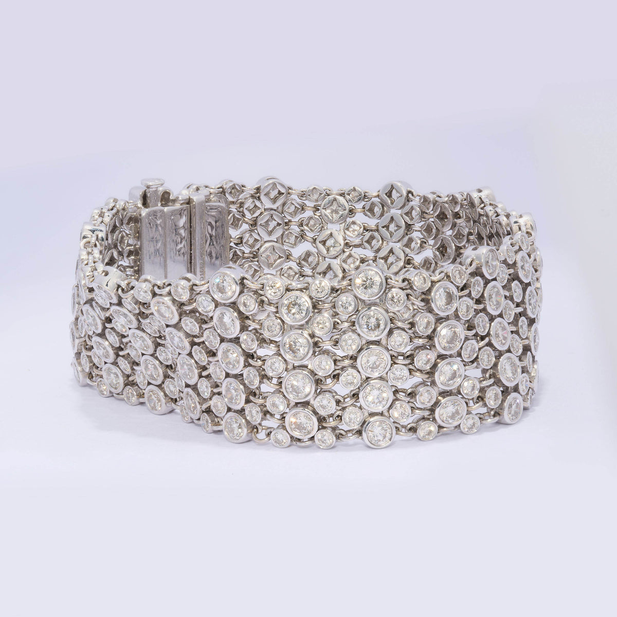 A wide multi-row bracelet set with brilliant cut diamonds in white gold