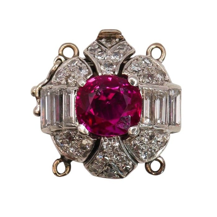 A ruby and diamond clasp in white metal