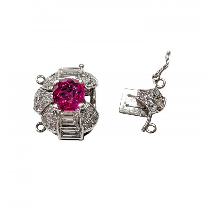 A ruby and diamond clasp in white metal