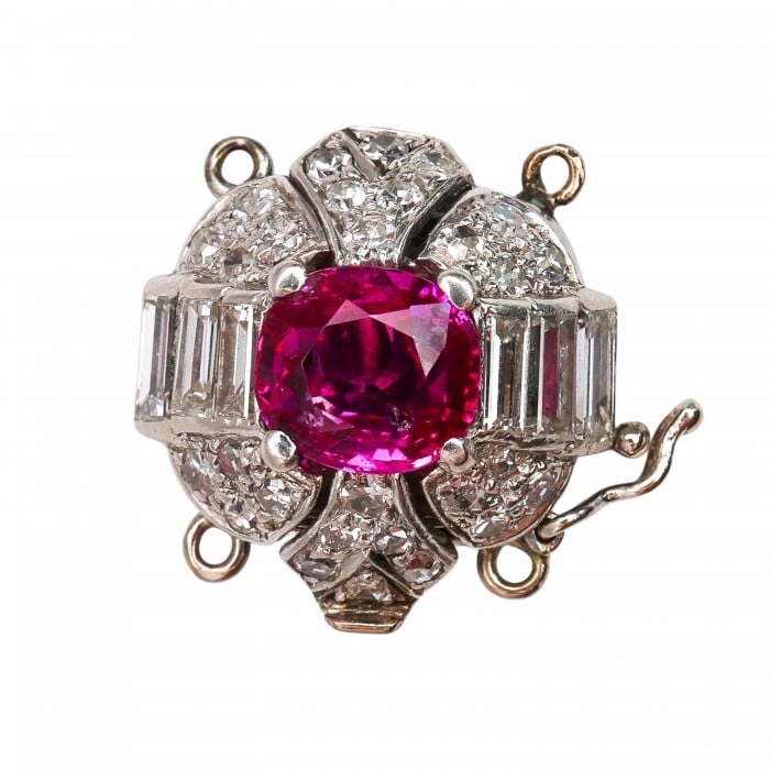 A ruby and diamond clasp in white metal