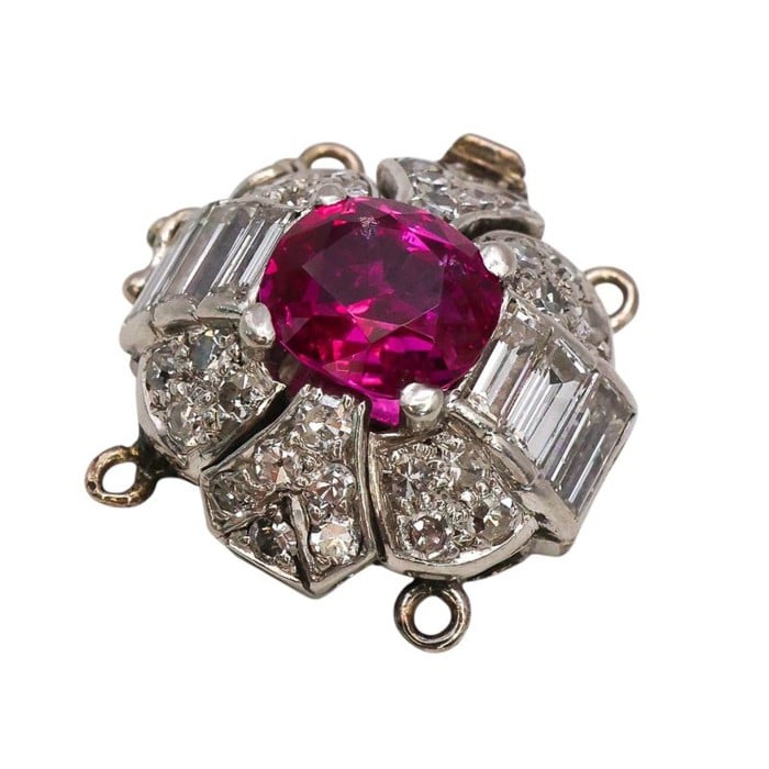 A ruby and diamond clasp in white metal