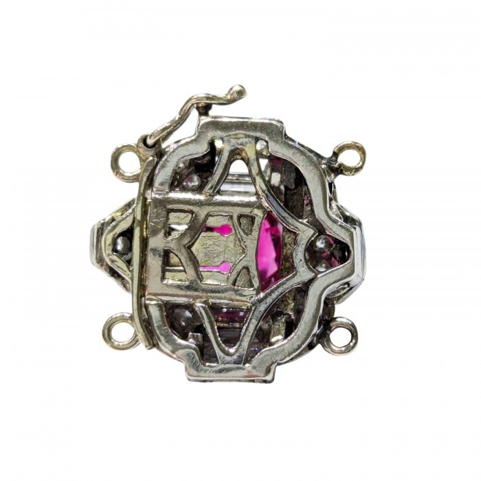 A ruby and diamond clasp in white metal