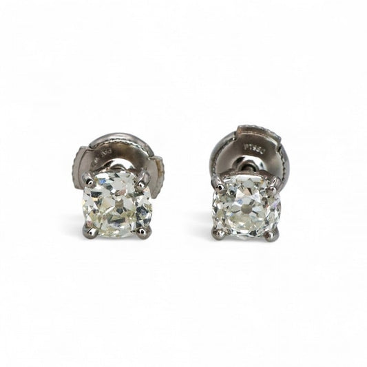 A pair of single stone diamond stud earrings, claw set in platinum