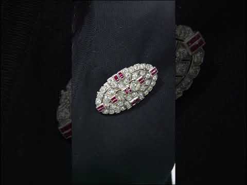 Video of an Art Deco diamond and ruby double clip brooch, in an oval, geometric design