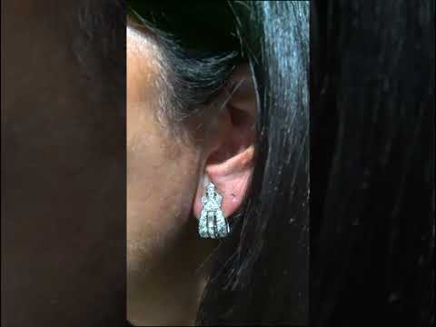 Video of a pair of platinum clips set with round and baguette cut diamonds