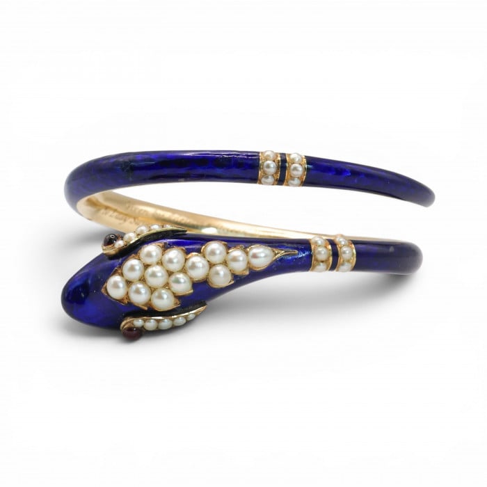 A snake bangle bracelet with pearls, ruby eyes and blue enamel, in yellow gold