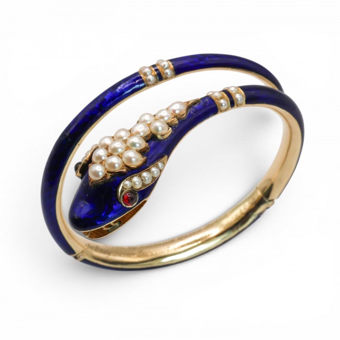 A snake bangle bracelet with pearls, ruby eyes and blue enamel, in yellow gold