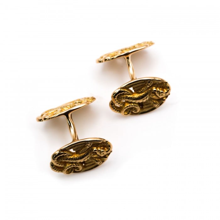 A pair of oval yellow gold cufflinks with dragon motifs
